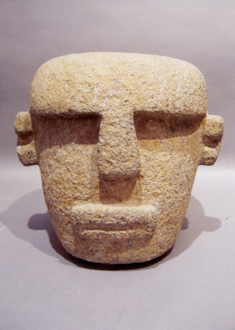 This is an image of an Olmec sculpture of a head made of volcanic stone around 500 BCE.