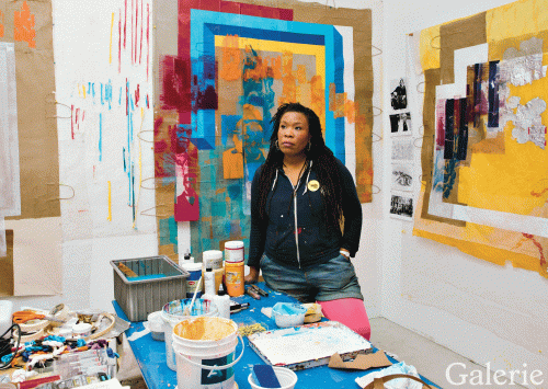 Tomashi Jackson in her studio surrounded by her colorful-layered assemblages. Jeremy Liebman